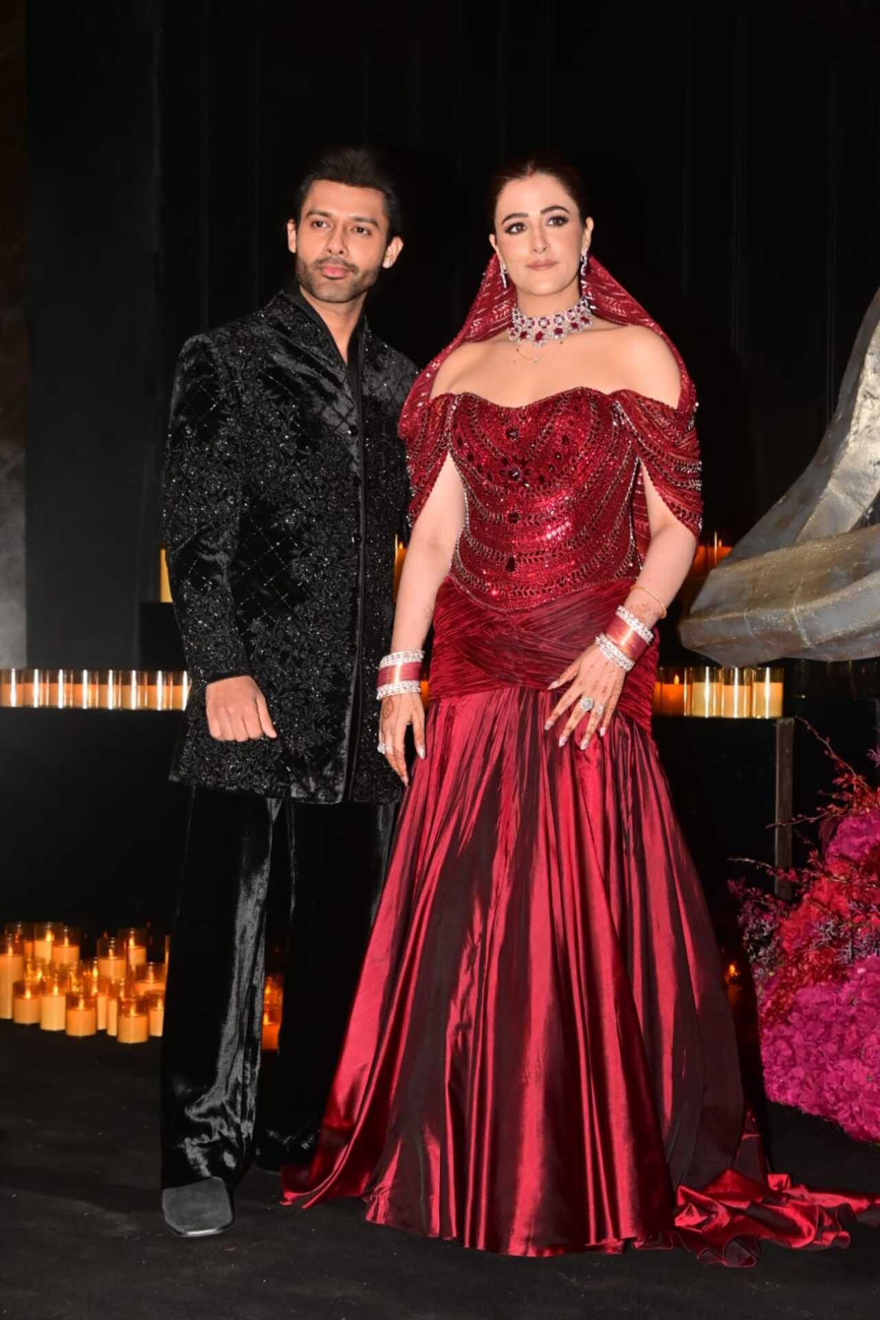 The newlyweds were seen posing for the paps ahead of their reception. Nupur wore a deep maroon off-shoulder gown with intricate detailing, while Stebin wore an embellished bandhgala.